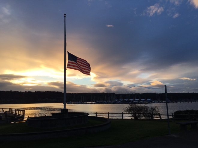 Sunset over Liberty Bay, with flag at halfmast